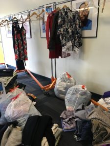 A picture of leftover donations from the DCGF Swap and Shop in white trash bags and on hangers 
