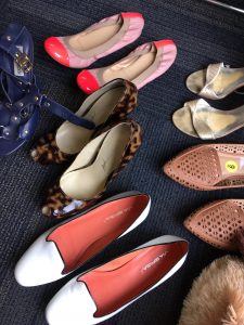 A picture of a few different pairs of shoes: leopard print heels, white shoes with pink soles, pink flats, silver open toed heels, and tan shoes