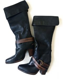 A picture of a pair of Steve Madden high boots with brown leather straps and buckles