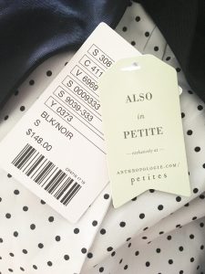 A picture of a polka dotted shirt with tags that say "also in petite" and "$148"
