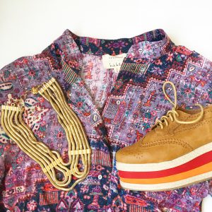 A picture of the top of a pattern-mixing, artistic, party button-down by designer Nicole Miller Atelier in a size medium, multi-colored, platformed, oxford cut shoes, and a five cord gold necklace