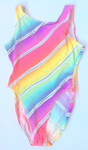 A picture of a pastel rainbow colored women's one piece Reebok bathing suit