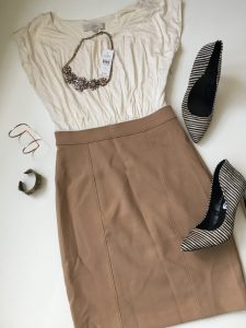 A picture of two-tone, cream and tan, brand new with tags, LOFT dress that is made from micro model material at the top and a polyester blend for the skirt, a pair of black and white, leather-upper zebra print Express pumps, a clear and orange bauble style bib necklace, and two bracelets, one thin gold one and the other a darker thicker styled one
