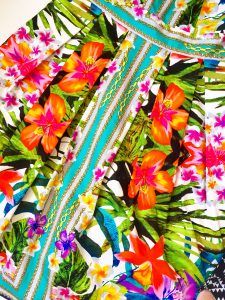 A close up of the bright, tropical floral pattern on the Maggy London dress