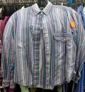 A picture of a vintage, 1990's, button up top. It has a few shades of blue and pink and has vertical stripes in different patterns