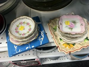 A picture of stacked, vintage plates with a floral pattern on top of them