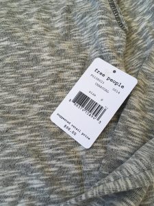 Granite gray, Free People long sleeve workout top tag. The tag indicates the original price of the pullover was $98