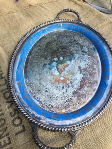 A picture of a silver tray with blue painters tape lining the edges.