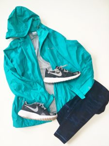 A picture of a blueish green, Arcadia-style, Columbia raincoat in a size small, a pair of gray and white Nike running shoes, and a pair of dark blue camo workout leggings