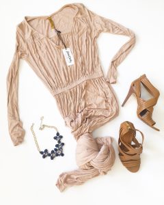 A picture of three items: a new with tags, modern, formal, designer, ribbed, bamboo colored, soft, Rachel Pally maxi dress in a size large, a pairing it with these strappy, tan, authentic Tory Burch heels in a size 7.5, and a dark navy blue and gold bauble necklace