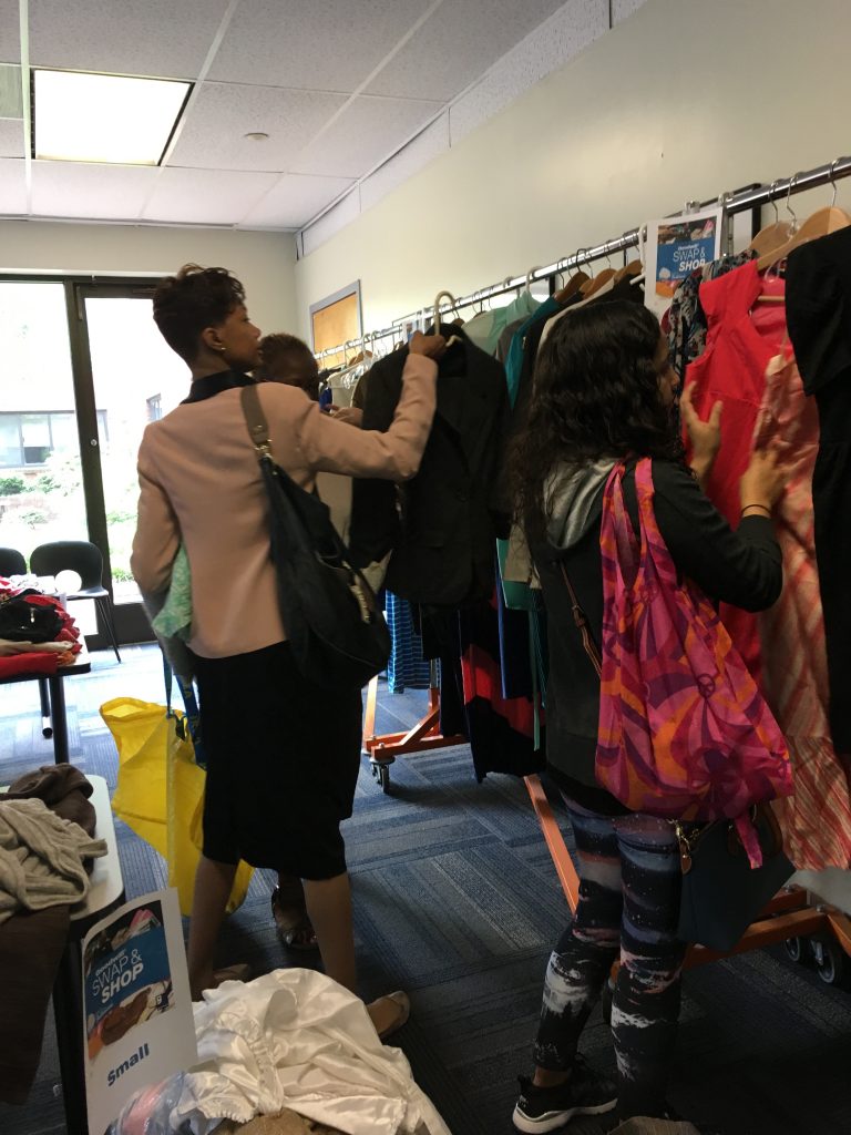 people shopping at clothing swap