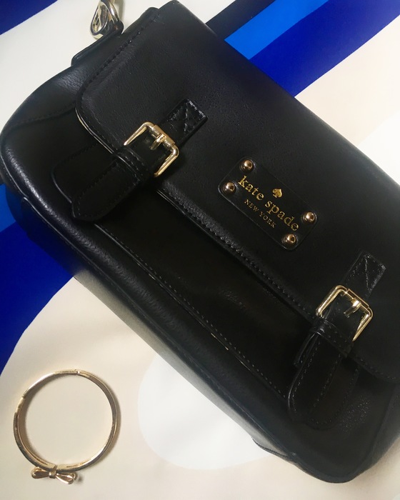 black kate spade crossbody bag and gold kate spade bow bracelet