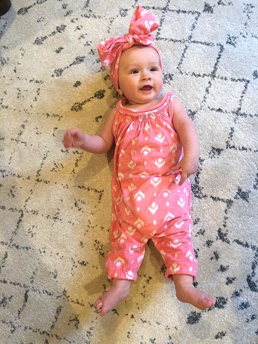 Ariel's infant daughter models the Goodwill tank, which has been upcycled as a romper and headband.