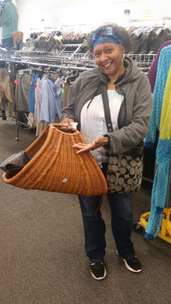 Meetup shopper shows off a wicker basket found at the Columbia Pike Goodwill