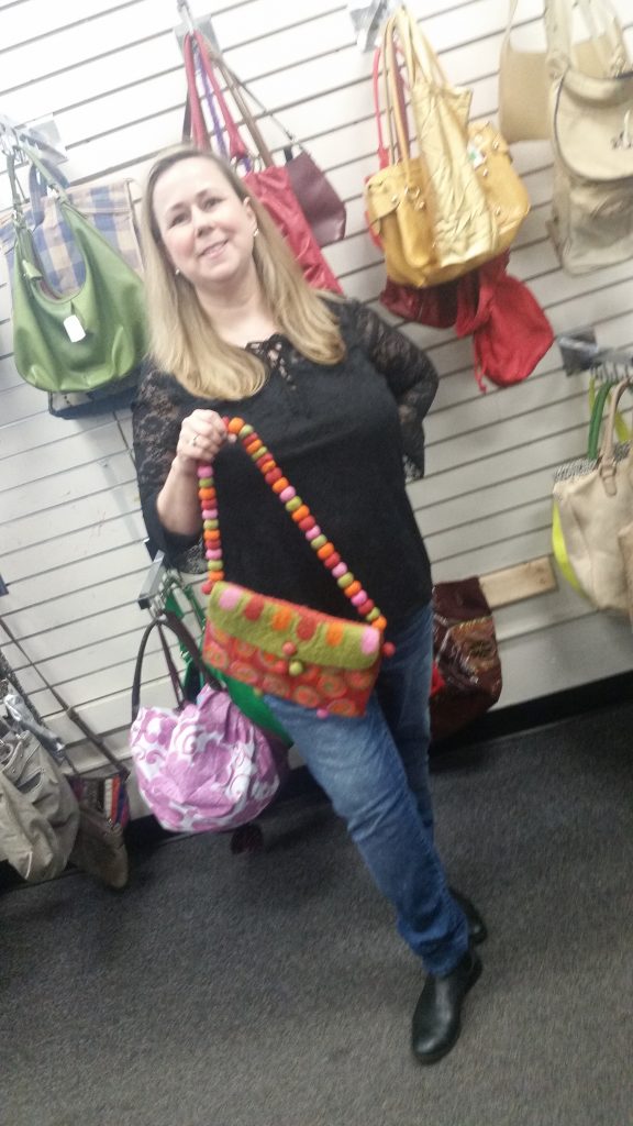 Meetup shopper poses with handmade knit purse found at Columbia Pike Goodwill