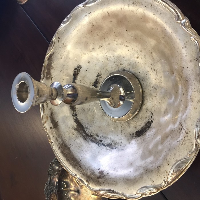 Tim stacks a candlestick holder atop a serving platter