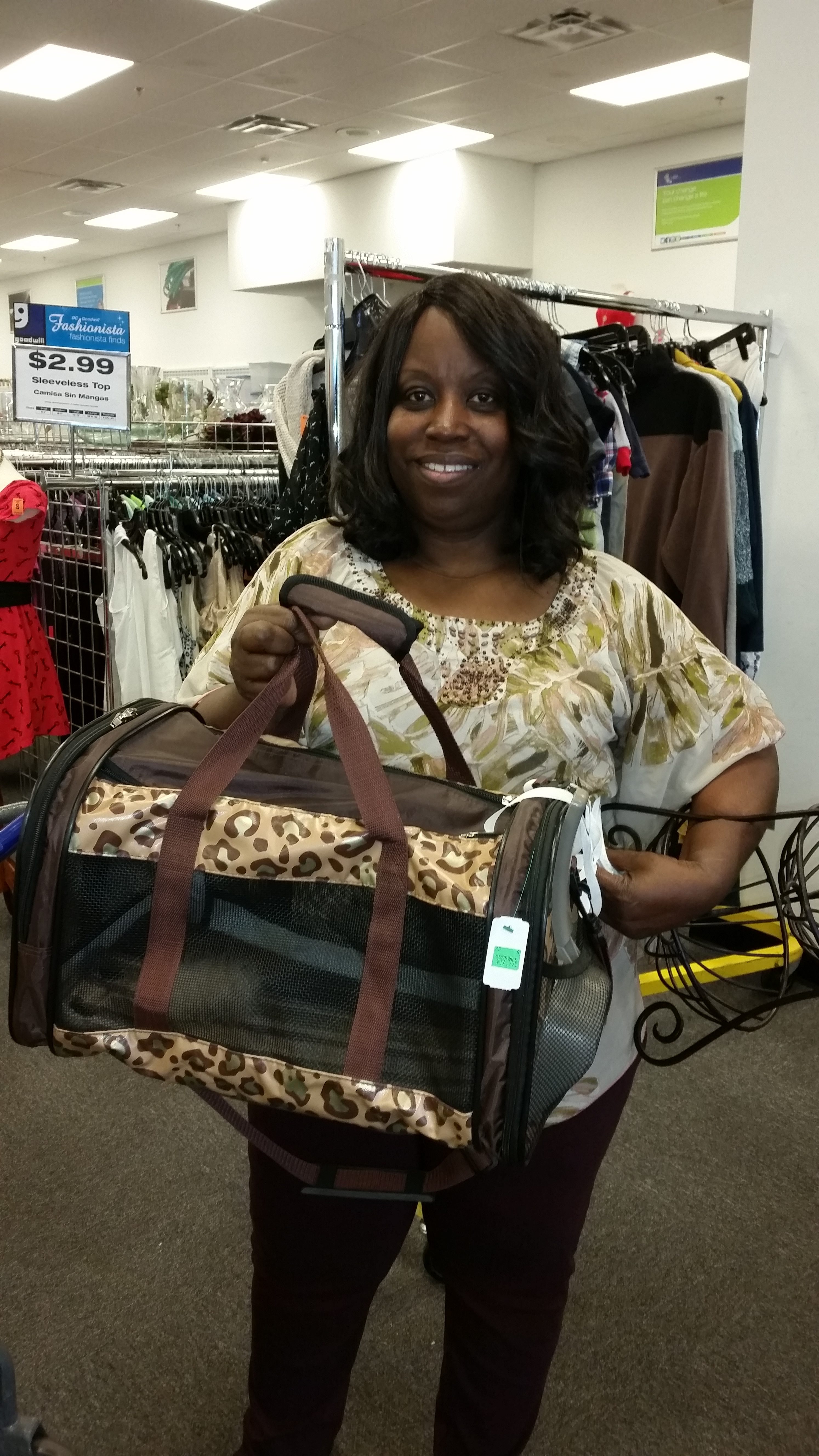 Meetup shopper poses with a pet carrier found at Goodwill