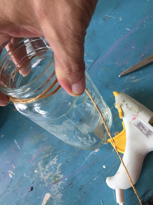 Tim wraps twine around mouth of mason jar