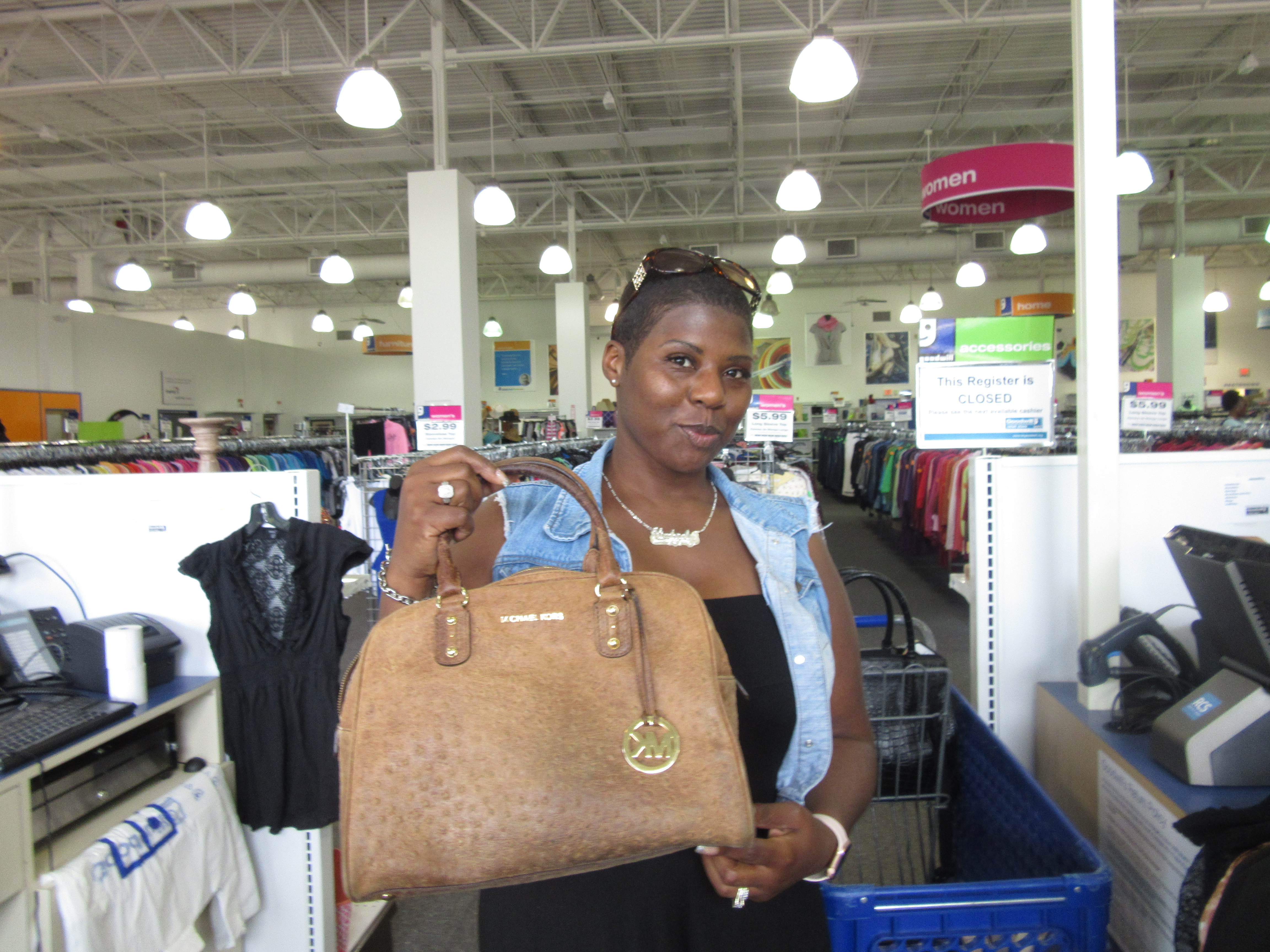 Meetup shopper poses with Michael Kors handbag found at Bowie Goodwill