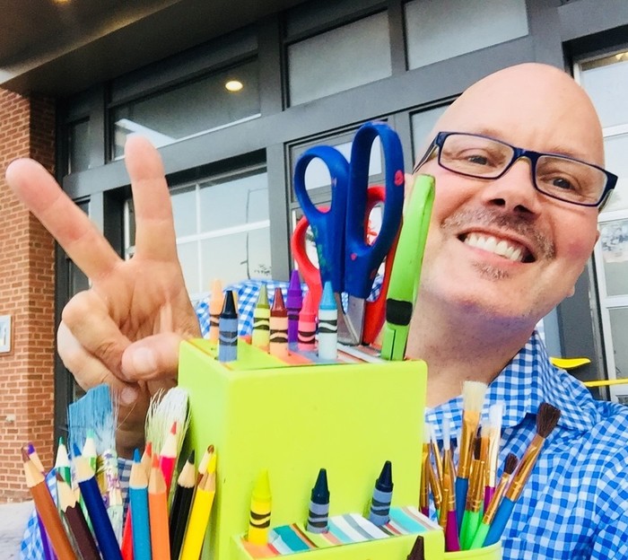 Tim poses with upcycled green knife block 