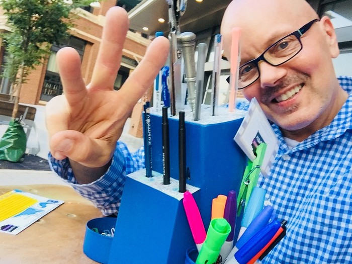 Tim poses with finished upcycled knife block painted blue