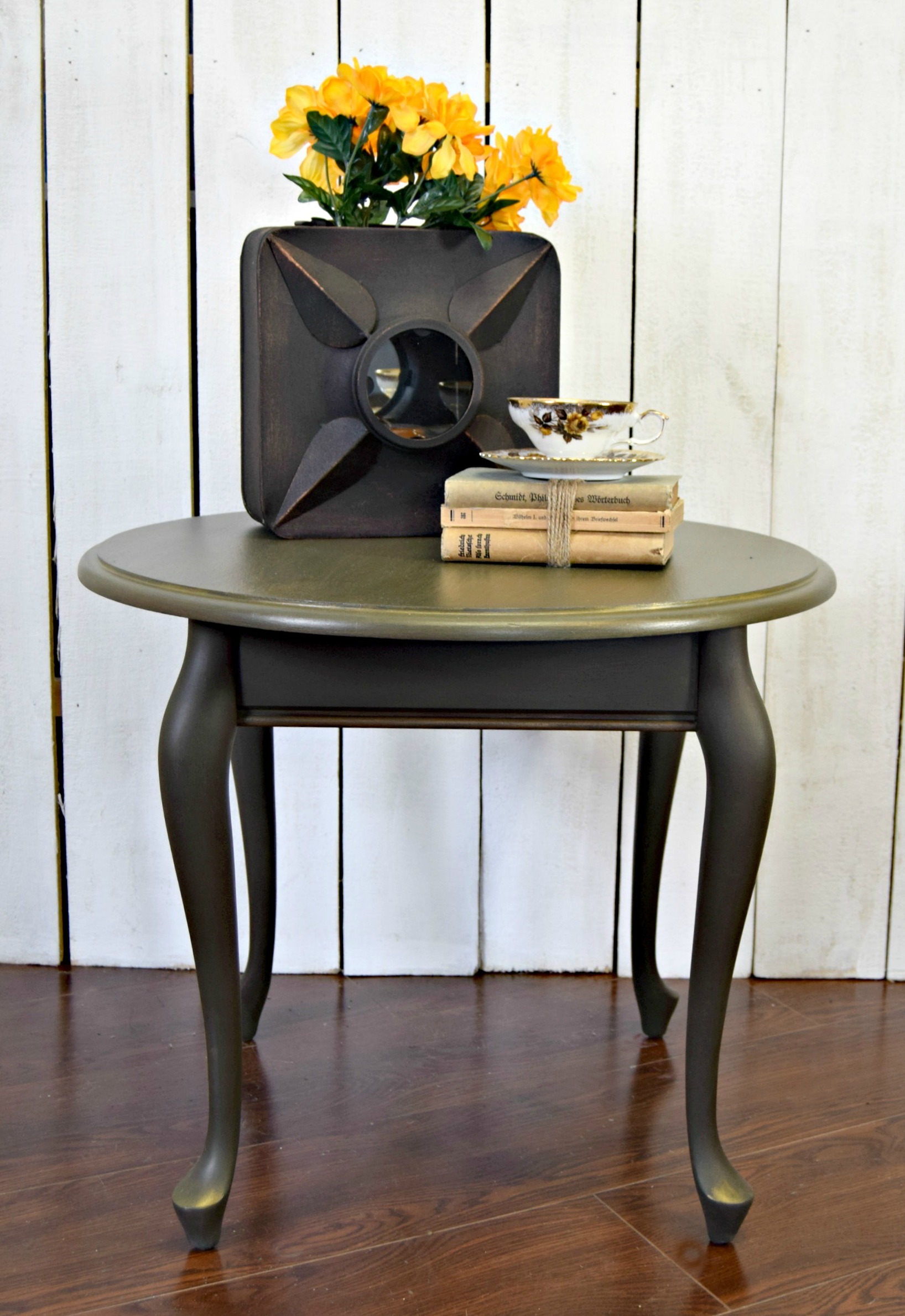 Courtney's little round table from Goodwill painted green and decorated with vintage accessories.