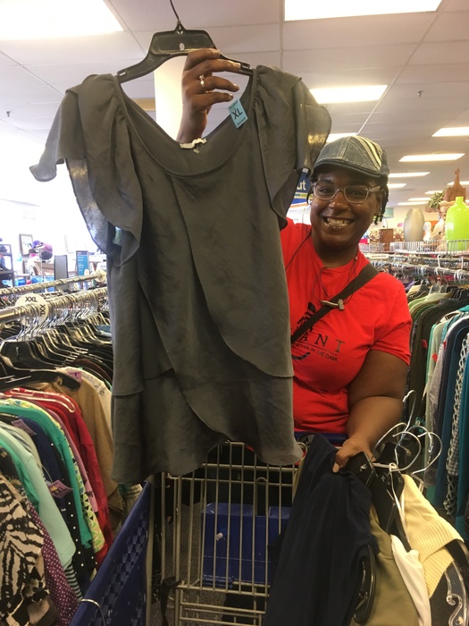 Shopper shows off blouse found at Waldorf Goodwill Meetup