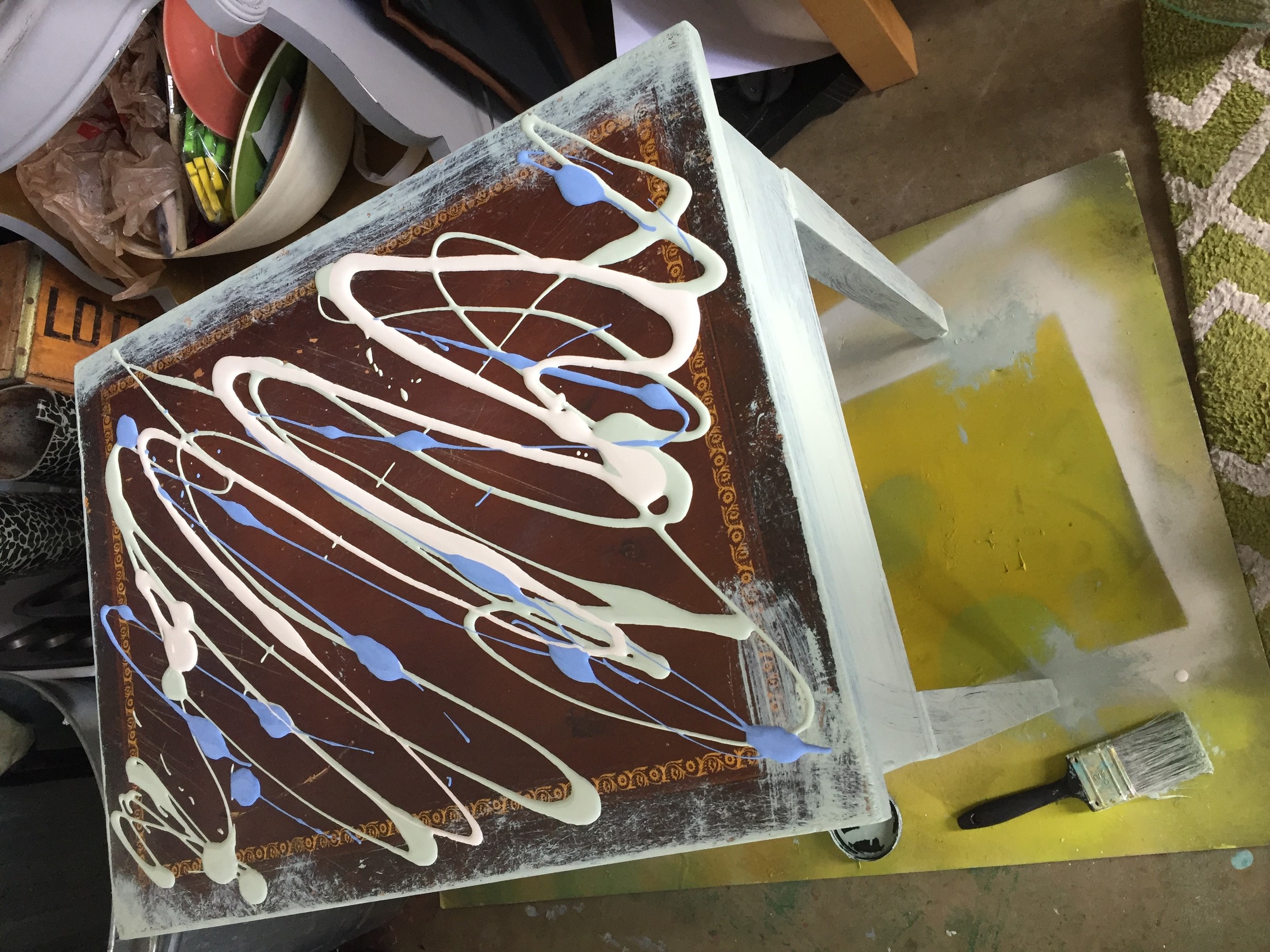 Tim's table from Goodwill covered in swirls of wet paint.