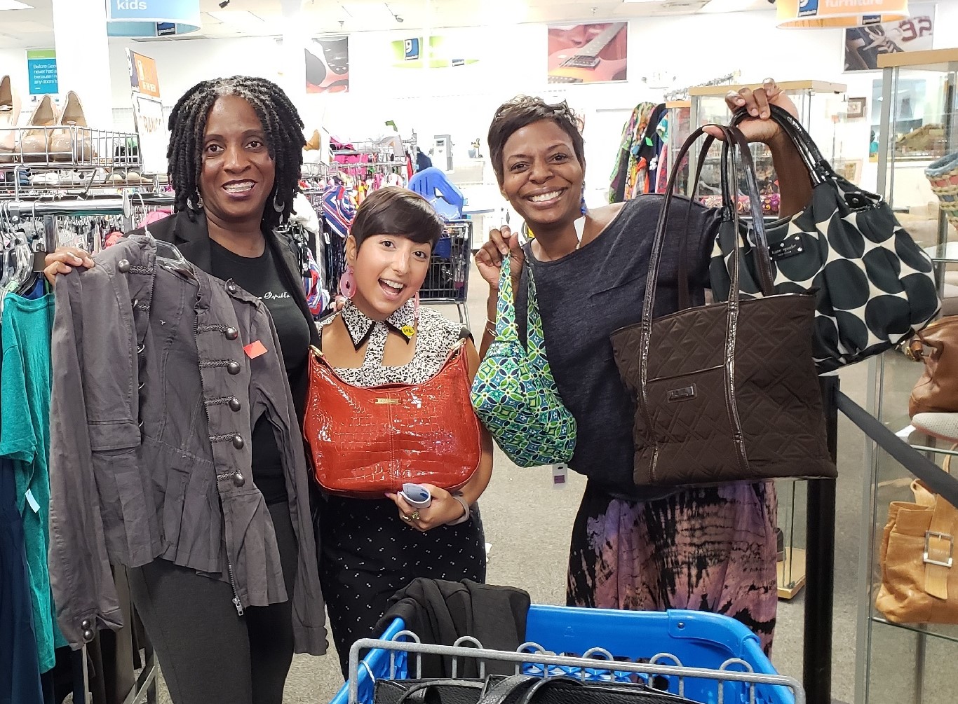 Carolyn poses with Meetup shoppers at Richmond Highway Goodwill store