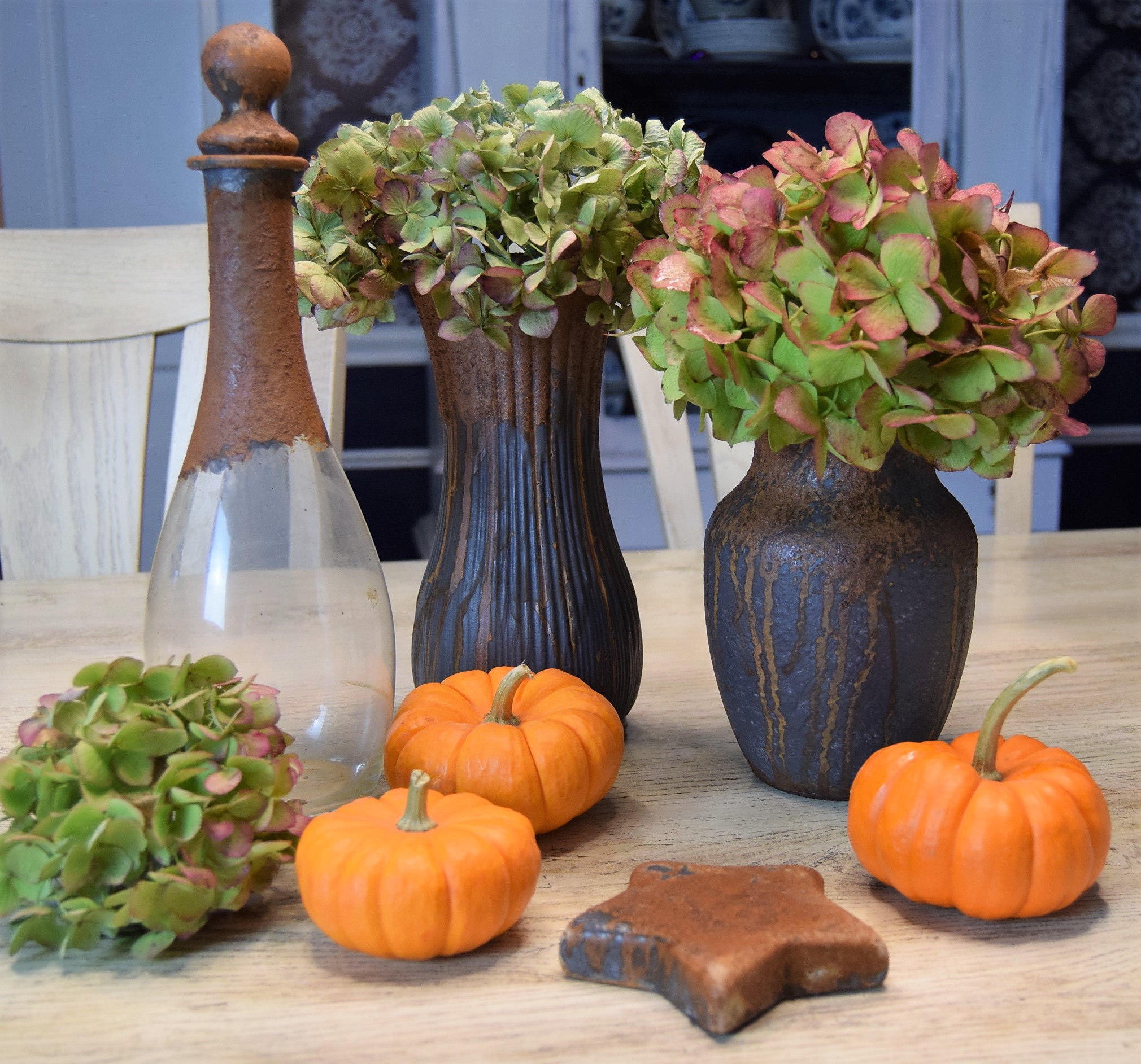 Courtney's beautiful tablescape decorated with patina painted items from Goodwill, pumpkins, and shrubs.