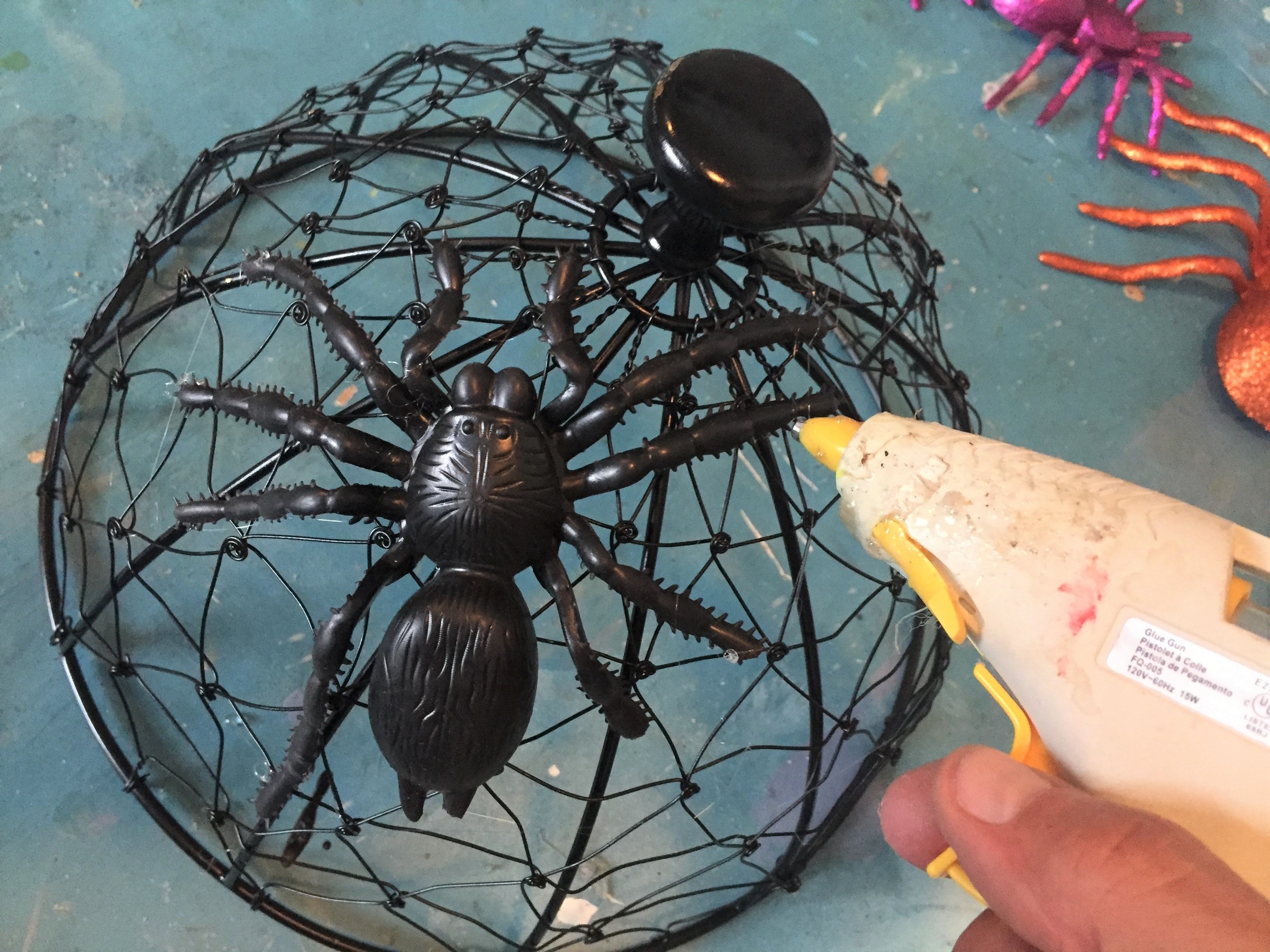 Tim glues a fake spider onto the spray-painted server