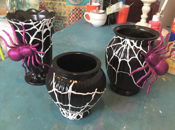 Tim attaches large purple spiders to two of the painted web vases