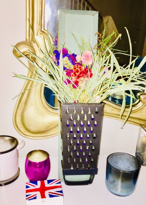 Tim's upcycled grater used to hold a floral arrangement