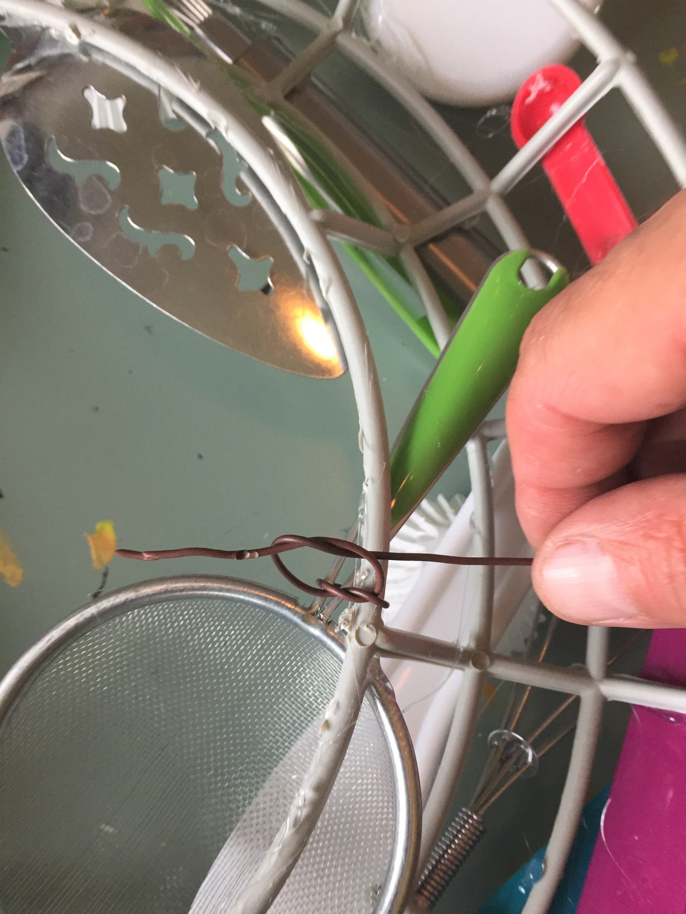 Tim uses wire to stabilize larger utensils.