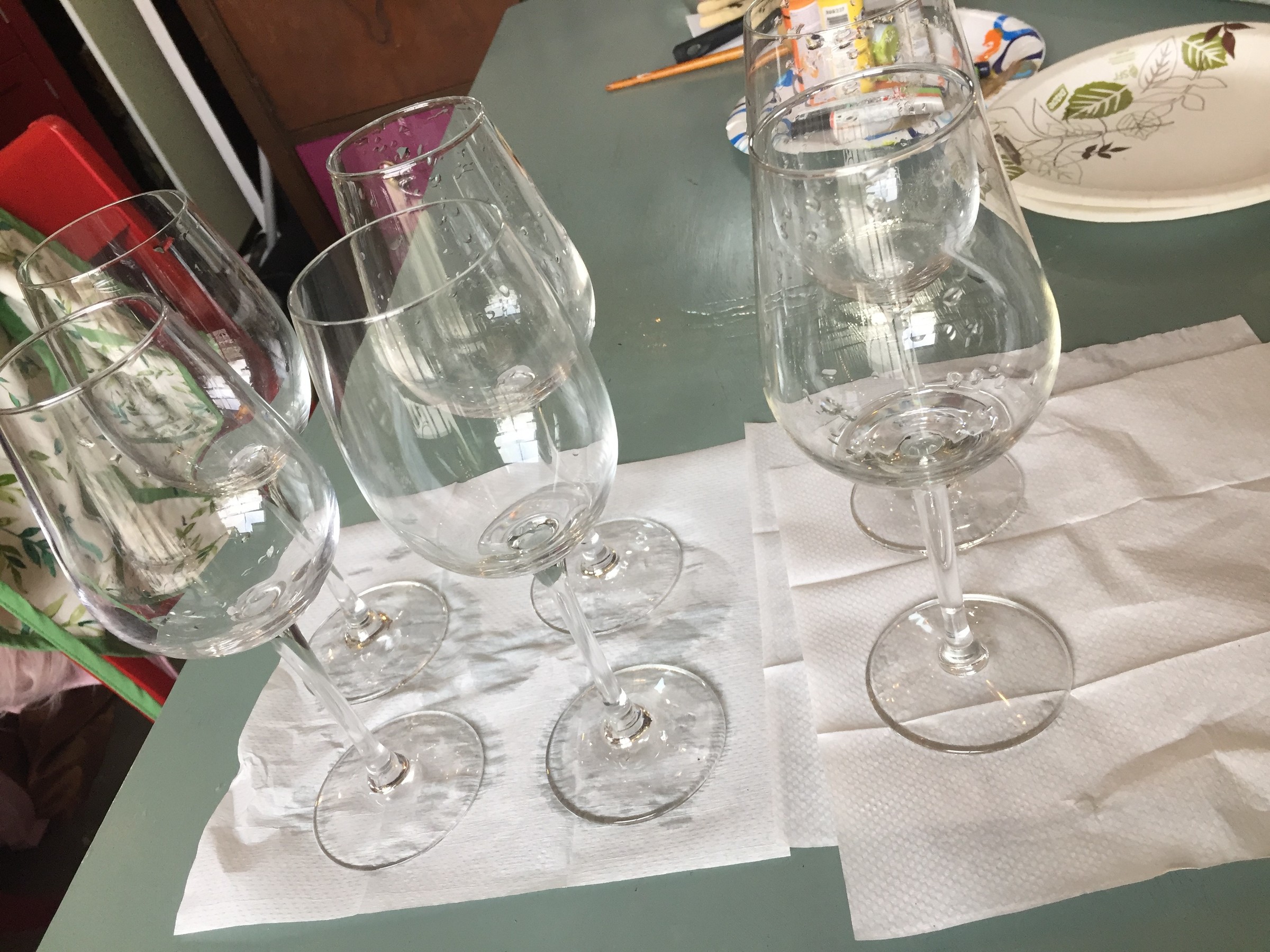 Tim's Goodwill wine glasses, washed and drying on paper towel